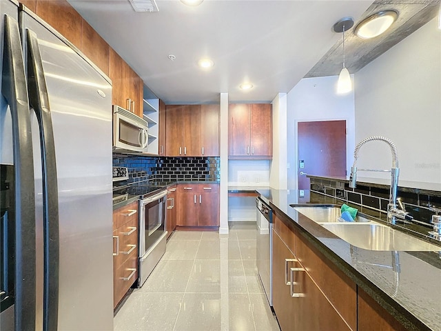 155 S Court Ave Unit 1610, Orlando, FL 32801 - kitchen with stainless steel appliances, decorative backsplash, light tile patterned floors, decorative light fixtures, and recessed lighting