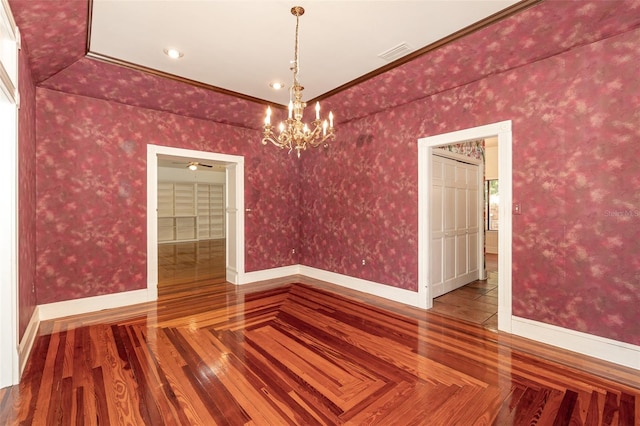 unfurnished dining area with ornamental molding, hardwood / wood-style floors, and an inviting chandelier