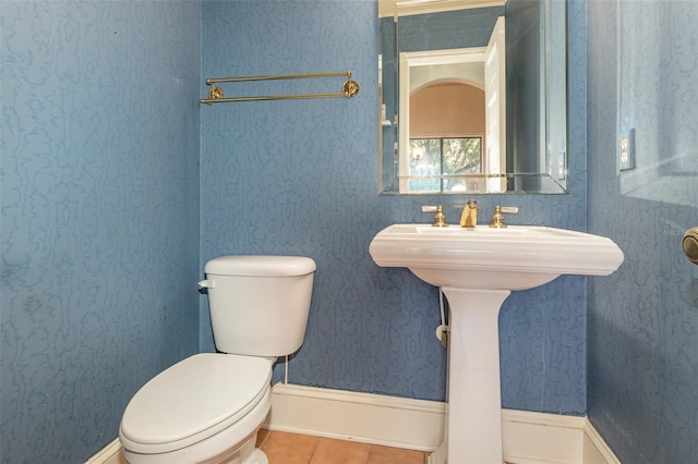 bathroom with tile patterned flooring, sink, and toilet