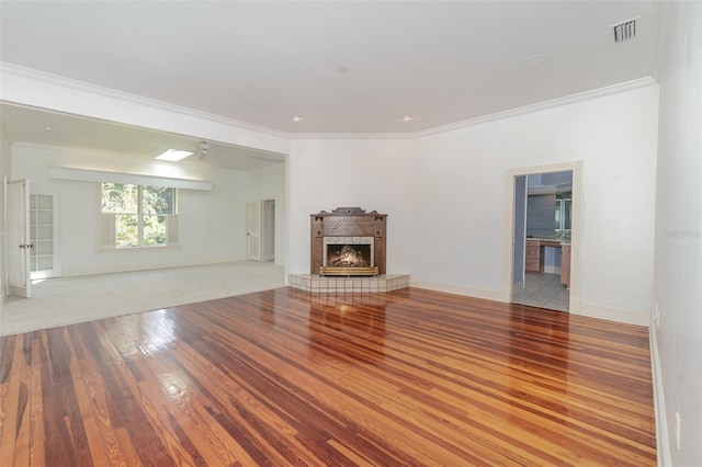 unfurnished living room with ornamental molding and light wood-type flooring