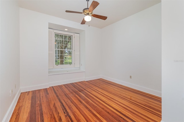 empty room with ceiling fan and wood-type flooring