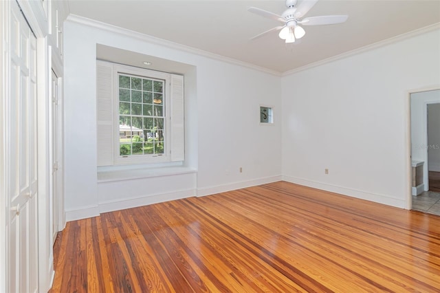 spare room featuring crown molding, ceiling fan, and hardwood / wood-style flooring