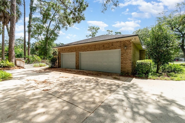 view of property exterior featuring a garage and an outdoor structure