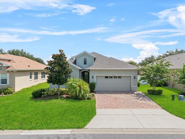 ranch-style house featuring a garage and a front lawn