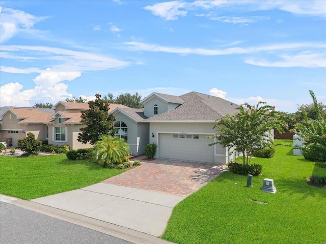 ranch-style home with a garage and a front lawn