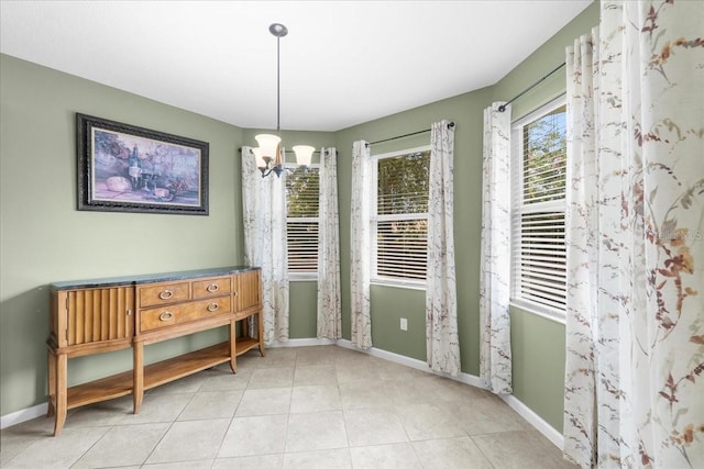 dining space with light tile patterned floors and a chandelier