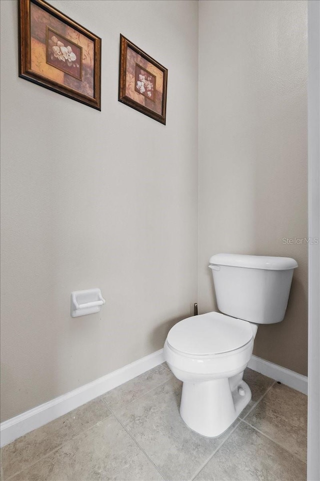 bathroom with tile patterned flooring and toilet