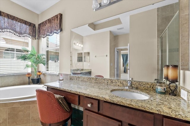 bathroom featuring vanity and separate shower and tub