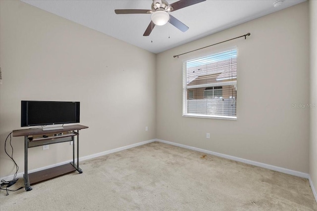 unfurnished room featuring light colored carpet and ceiling fan