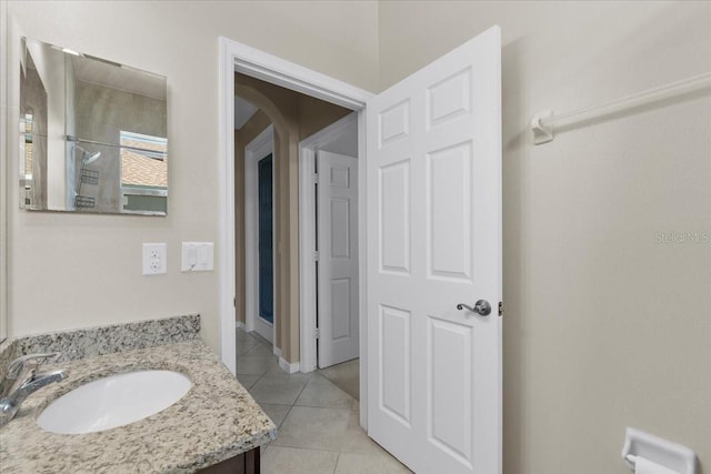 bathroom featuring walk in shower, vanity, and tile patterned flooring