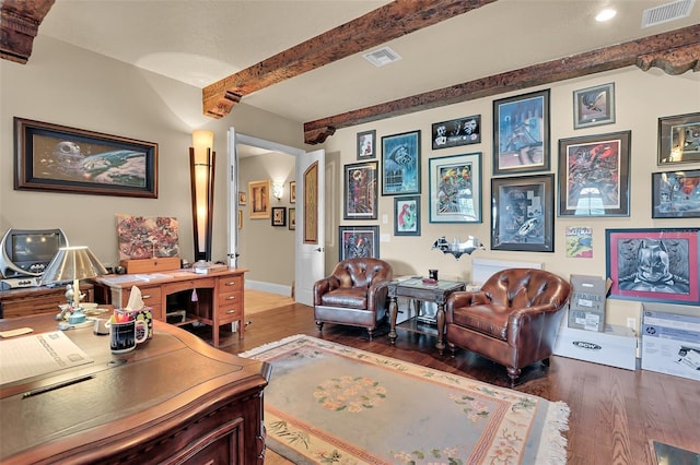 office space featuring beam ceiling, visible vents, and wood finished floors