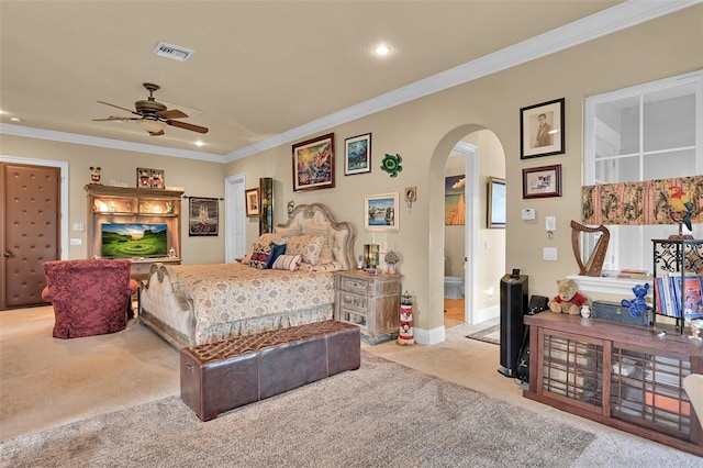 bedroom featuring ceiling fan, crown molding, and light colored carpet