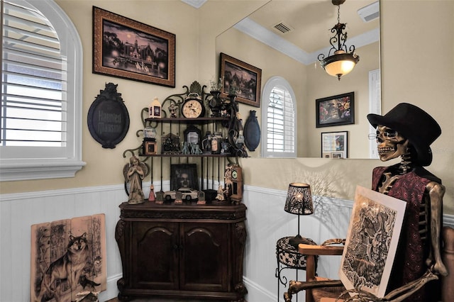 interior space with visible vents, arched walkways, and wainscoting