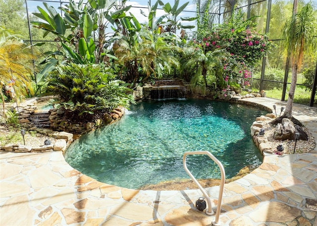 view of pool featuring pool water feature, a patio area, and a garden pond