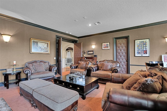 living room with a textured ceiling, ornamental molding, and carpet flooring