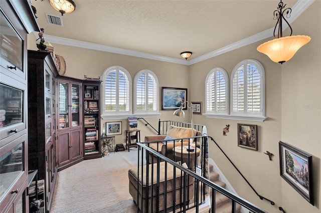 staircase with visible vents, crown molding, and carpet