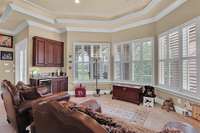 living room featuring light colored carpet, a healthy amount of sunlight, wine cooler, and crown molding