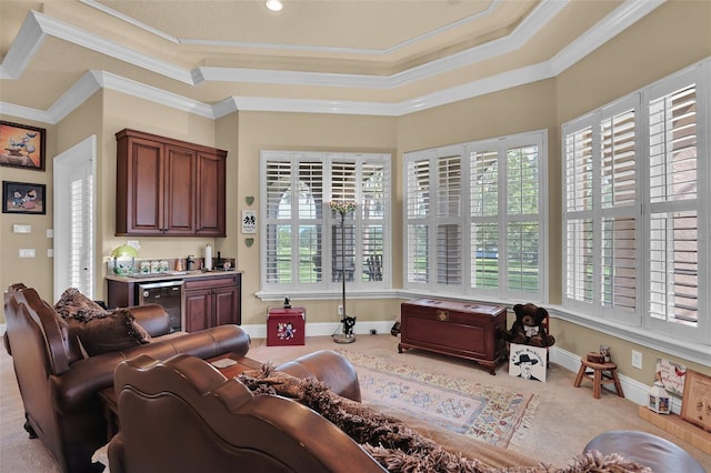 living area featuring carpet, a raised ceiling, beverage cooler, and a wealth of natural light