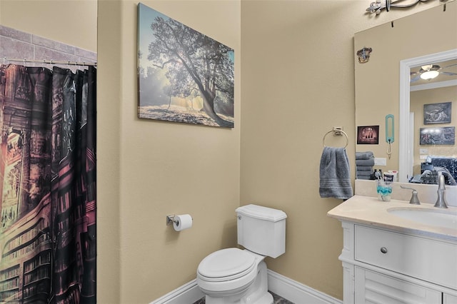 bathroom with toilet, vanity, and a shower with shower curtain