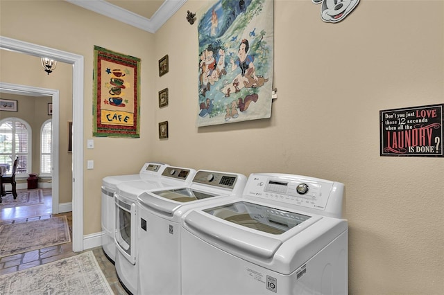 clothes washing area featuring ornamental molding and independent washer and dryer