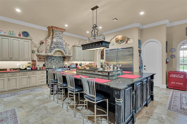 kitchen with a large island, custom range hood, stainless steel appliances, crown molding, and decorative backsplash