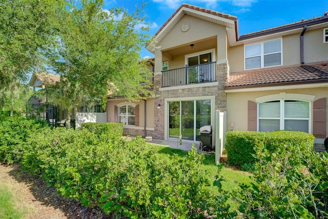 rear view of property with a balcony