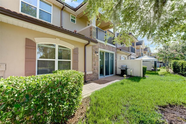 rear view of property featuring a yard