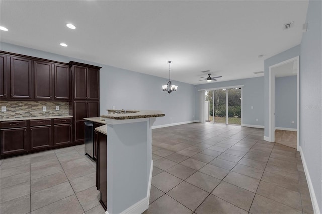 kitchen with pendant lighting, dishwasher, backsplash, a center island, and light tile patterned flooring