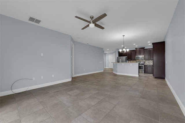 unfurnished living room featuring light tile patterned floors and ceiling fan with notable chandelier