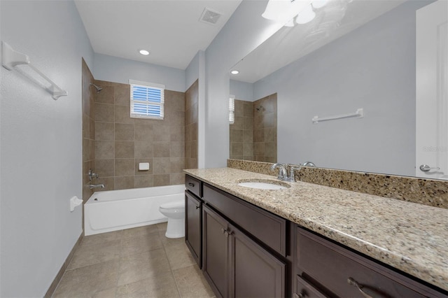 full bathroom with tiled shower / bath combo, vanity, tile patterned flooring, and toilet