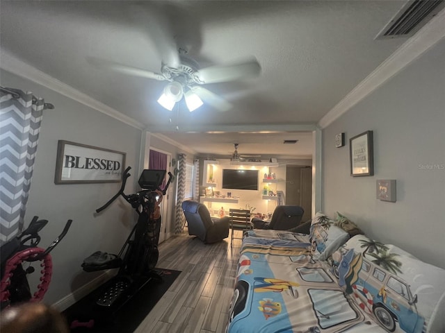 interior space with hardwood / wood-style flooring, crown molding, and ceiling fan