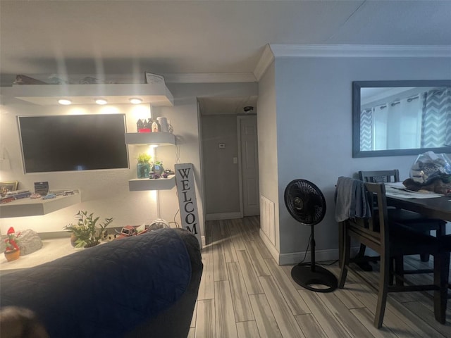 living room with hardwood / wood-style flooring and crown molding