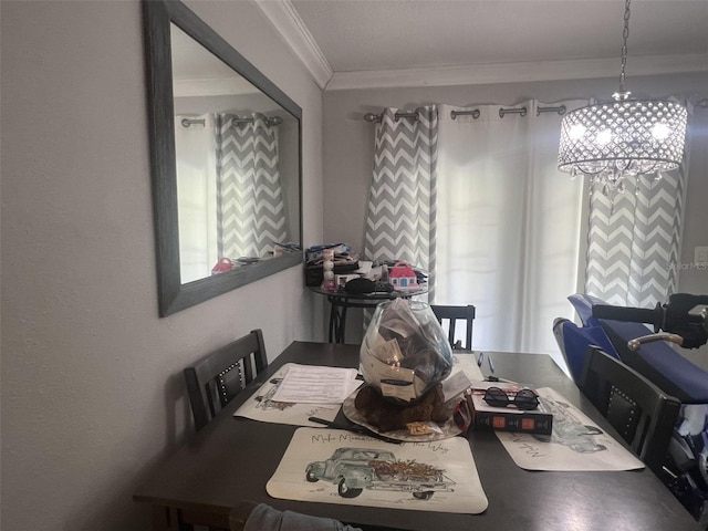 dining area featuring crown molding and a chandelier