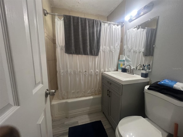 full bathroom with vanity, shower / bath combo with shower curtain, and toilet