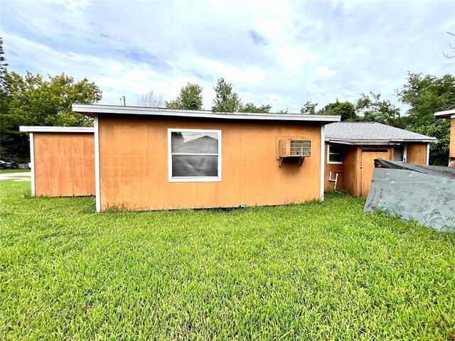 view of side of home with a lawn