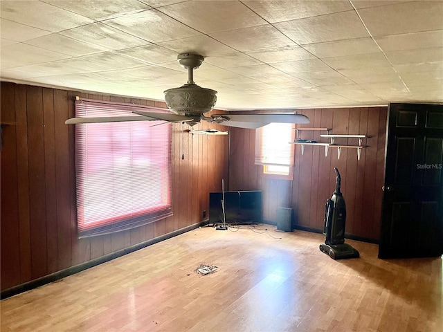 exercise room featuring wood-type flooring and wooden walls