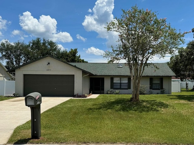 ranch-style home featuring a garage and a front yard