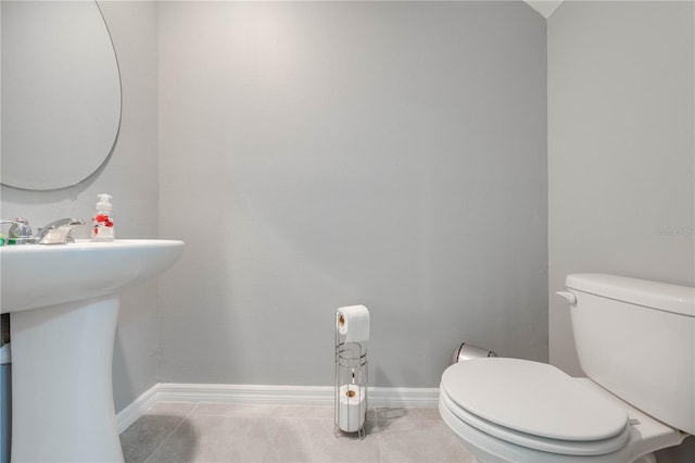 bathroom with toilet and tile patterned flooring