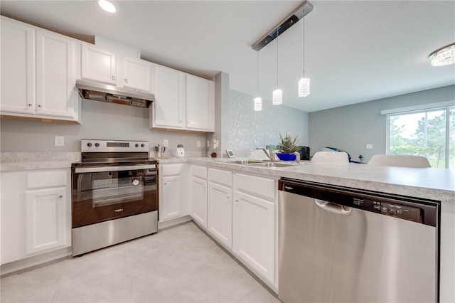 kitchen with white cabinetry, hanging light fixtures, sink, appliances with stainless steel finishes, and light tile patterned floors