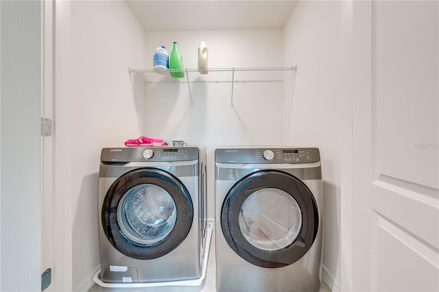 clothes washing area with washing machine and dryer