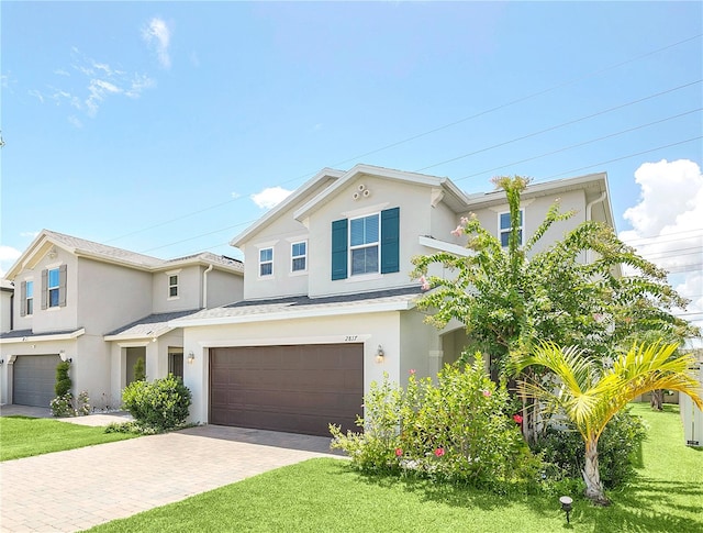 view of front of property with a garage and a front yard