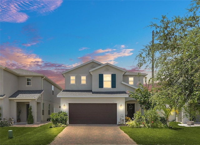 view of front of home featuring a garage and a yard