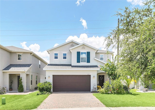 view of front of home with a garage and a front lawn