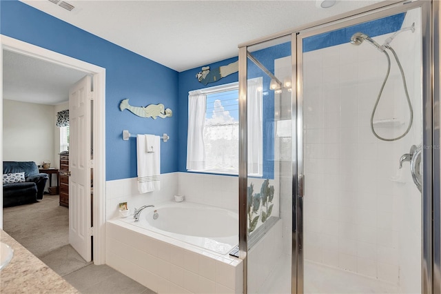 bathroom with vanity, plus walk in shower, and tile patterned flooring