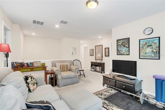 living room featuring light carpet and a textured ceiling