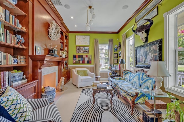 living area with ornamental molding and a high end fireplace