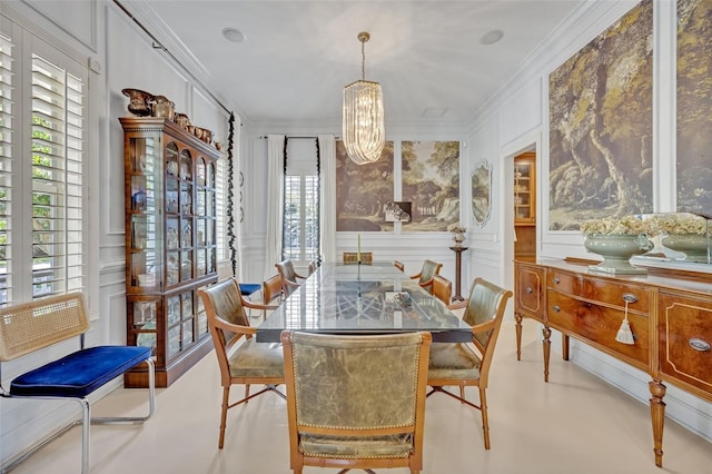 dining room featuring crown molding, plenty of natural light, and an inviting chandelier