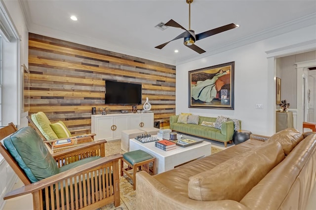 living room featuring crown molding, ceiling fan, and wooden walls