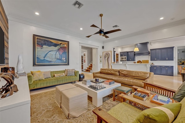 living room with crown molding and ceiling fan