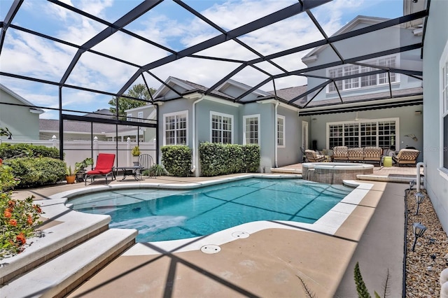 view of pool featuring an in ground hot tub, glass enclosure, and a patio area